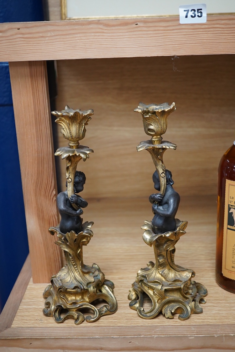 A pair of decorative French ormolu figural candlesticks, 25.5cm high